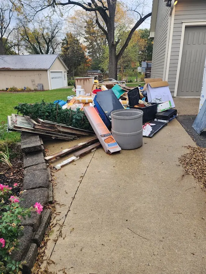 Dumpster being loaded with debris for 10 Yard Dumpster Rental in McRae-Helena